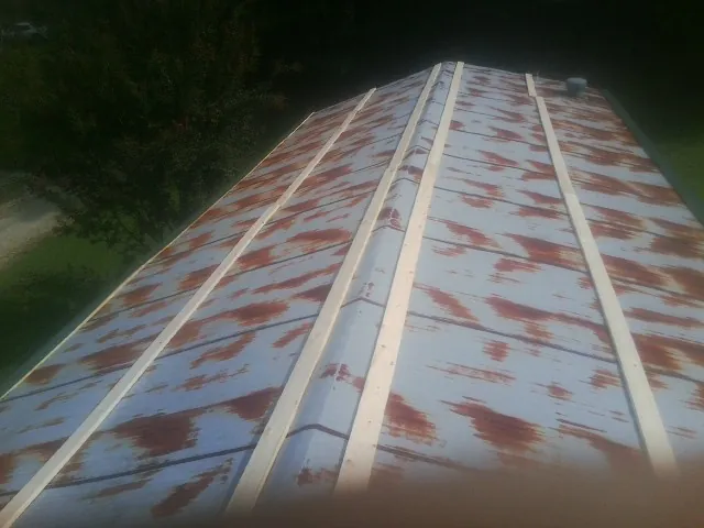 Rusted metal roof panels with new wood purlins before replacement — Storm Damage Roof Repair in Driftwood by Roofing Brothers